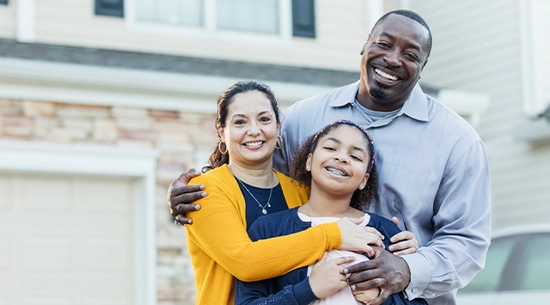 Photo showing diverse family in front of house, used on brochure cover